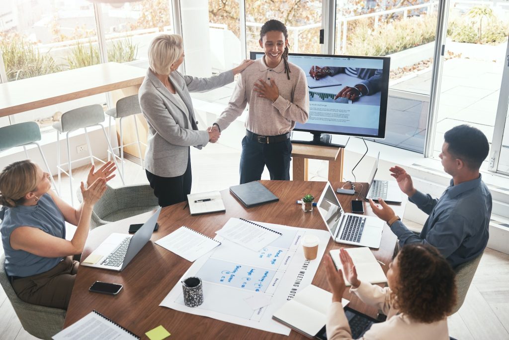 Business handshake, woman and applause at team building for company growth and b2b. Working, market