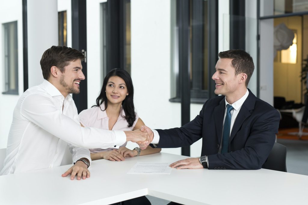 Consultant shaking hands with man